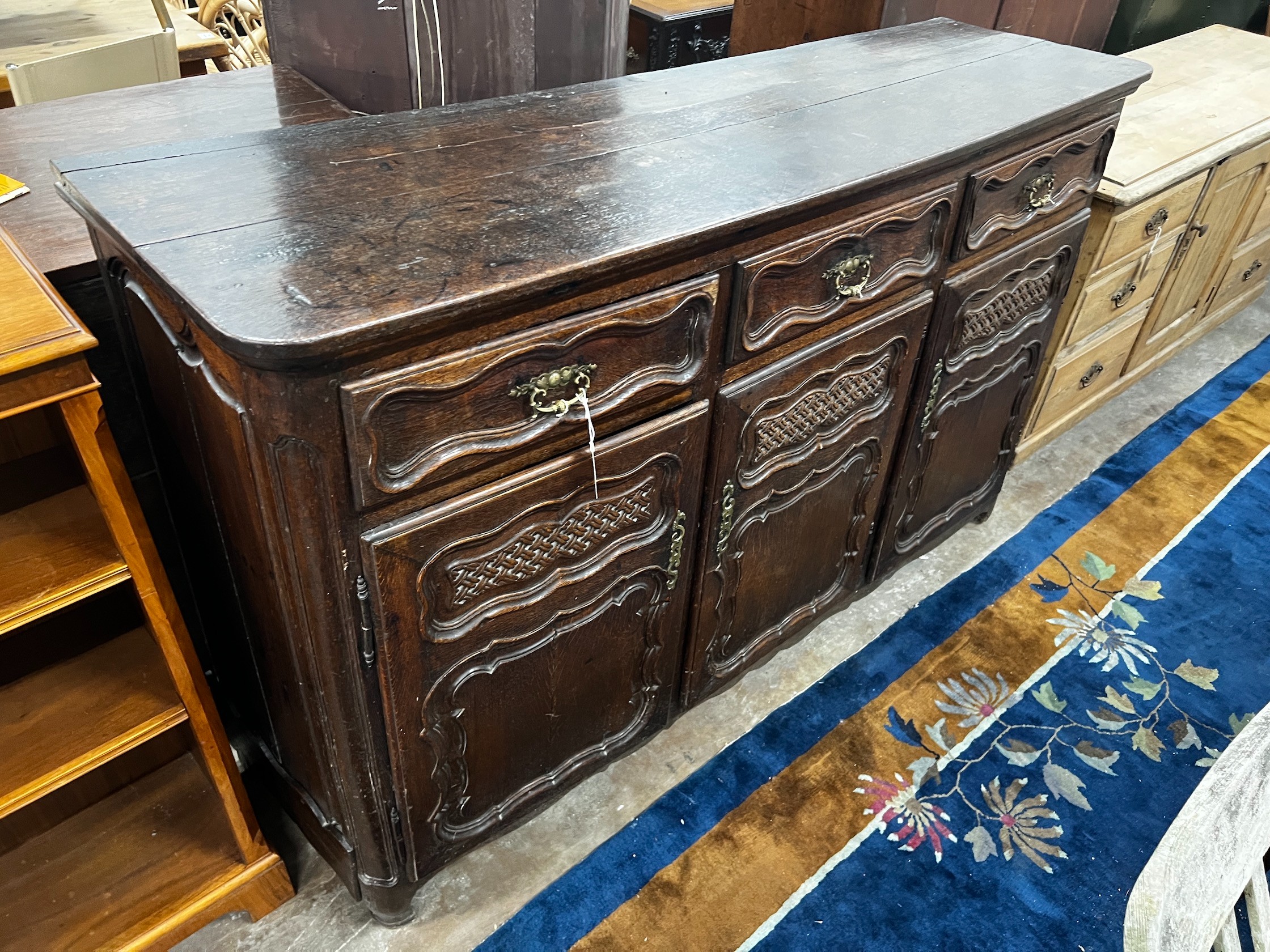 An 18th century French Provincial oak buffet, lacking two feet, width 171cm depth 48cm height 110cm